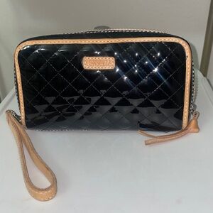 Consuela Jax Wristlet Wallet. Glossy black cross-stitched exterior, leather trim